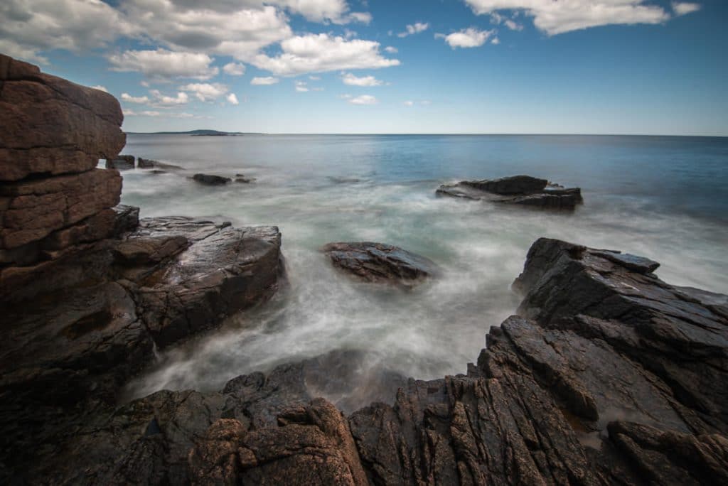 Ocean waves crashing over the rocks of the Great Head Trail in Acadia National Park