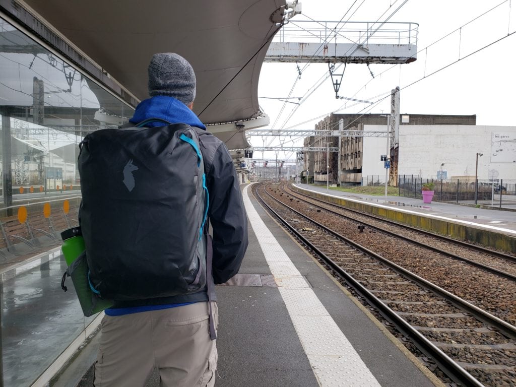 Buddy waiting for train in France during our long-term house sitting trip through Europe