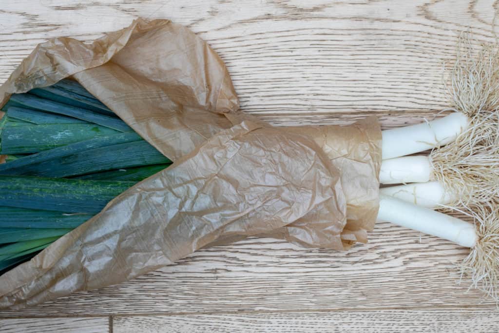 bundle of leeks in brown paper