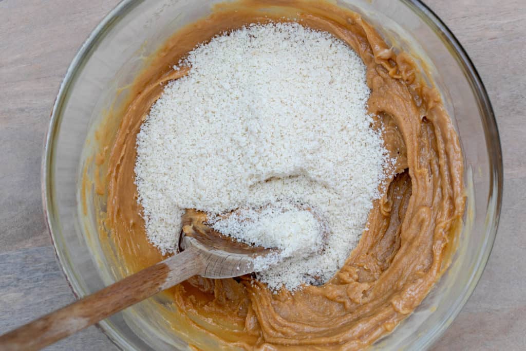 stirring almond flour into peanut butter dough