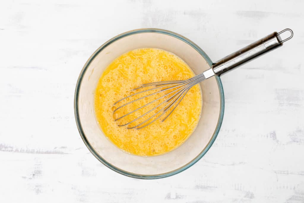 whisked eggs in glass bowl