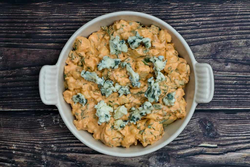 buffalo cauliflower dip in baking dish, ready for oven