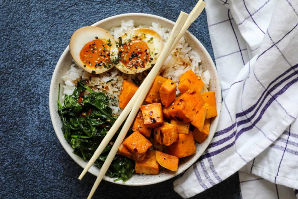 Ramen egg rice bowl in bowl with napkin and chopsticks