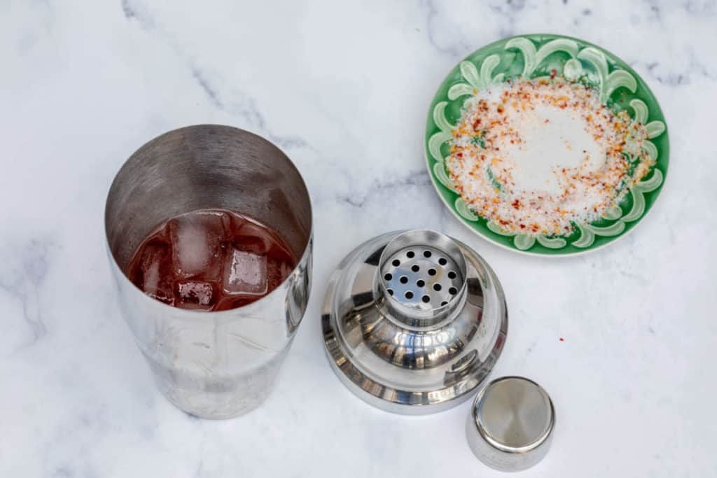 cocktail shaker with margarita and saucer with salt and pimente d'espelette