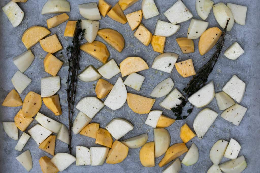 chopped turnips tossed with olive oil, honey, and thyme on sheet pan