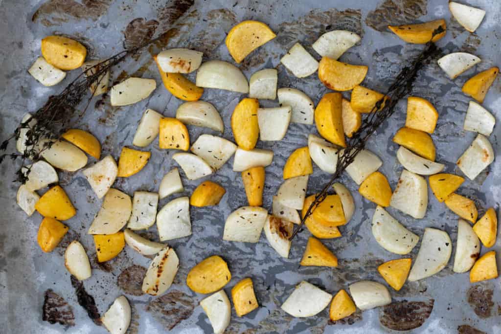 Roasted turnips on sheet pan with thyme sprigs