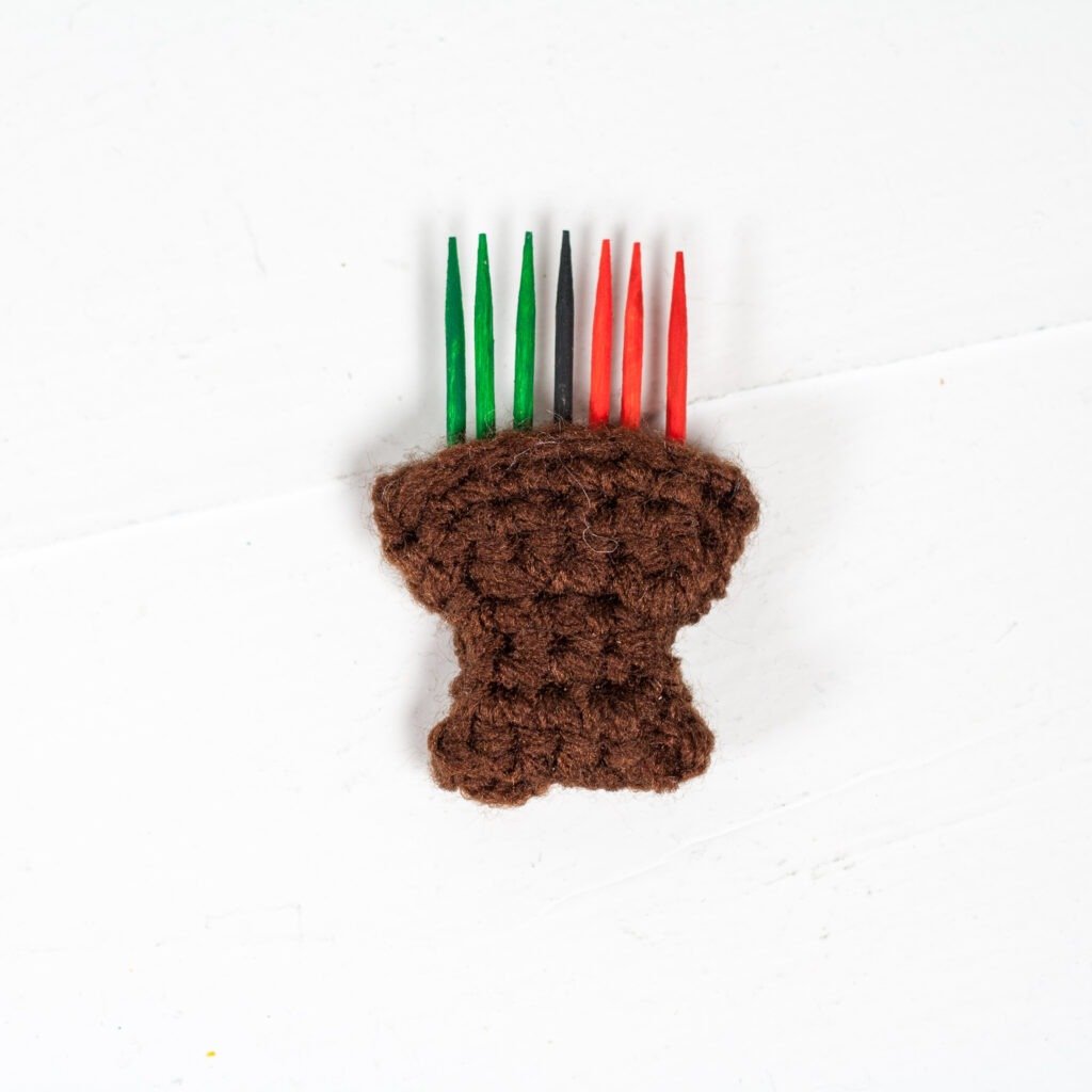 Celebrate the holidays with this crochet Kwanzaa gnome. Free crochet pattern for a fun holiday decoration with video tutorials.