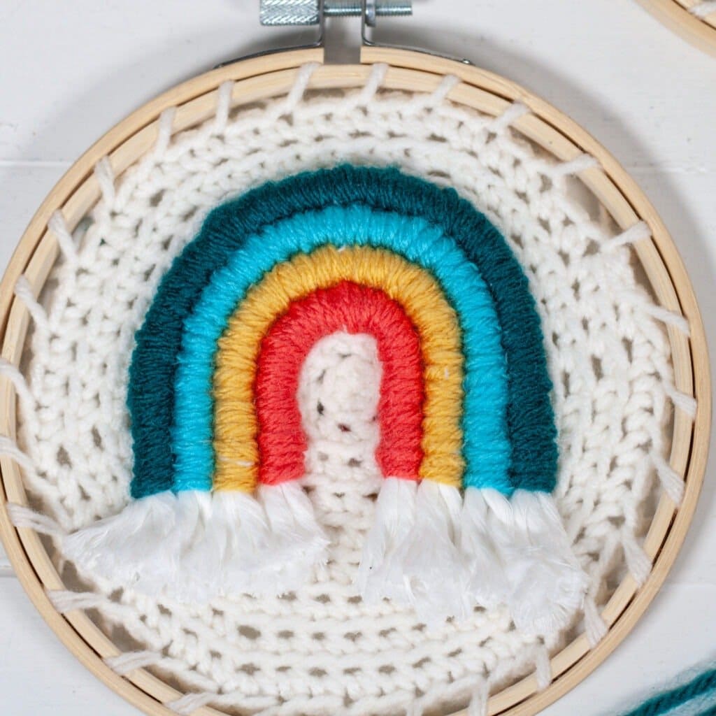 Learn how to make embroidery crochet rainbow wall hanging. You will be using your crochet skills and learning to embroider with a video.