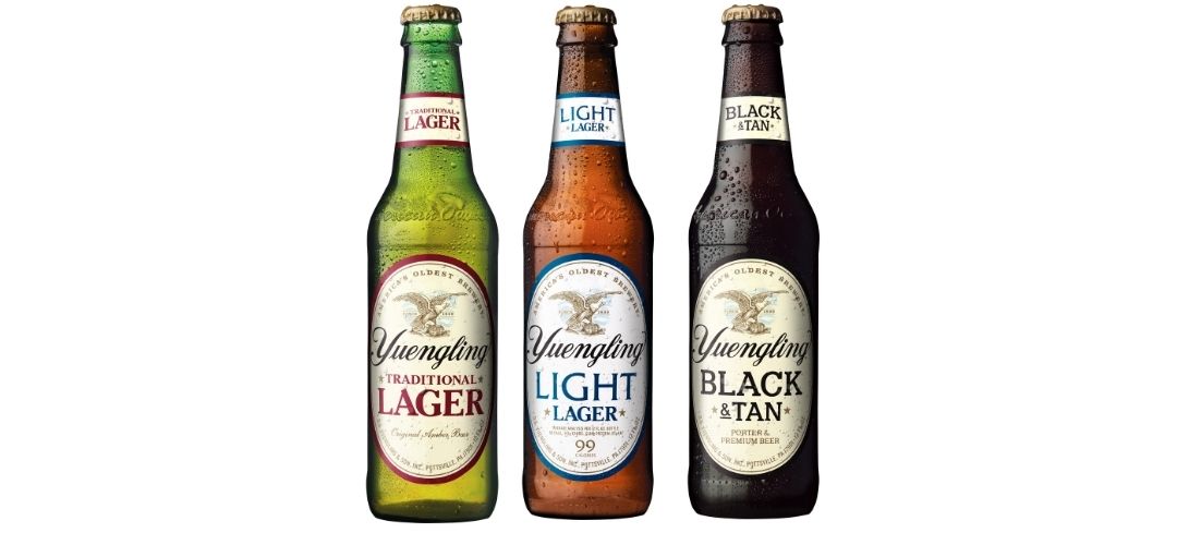 Three Yuengling beers in bottles. The Traditional Lager, Light Lager, and Black & Tan
