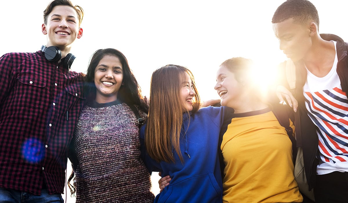 Group Of School Friends Outdoors Arms Around One Another Togetherness And Community Concept