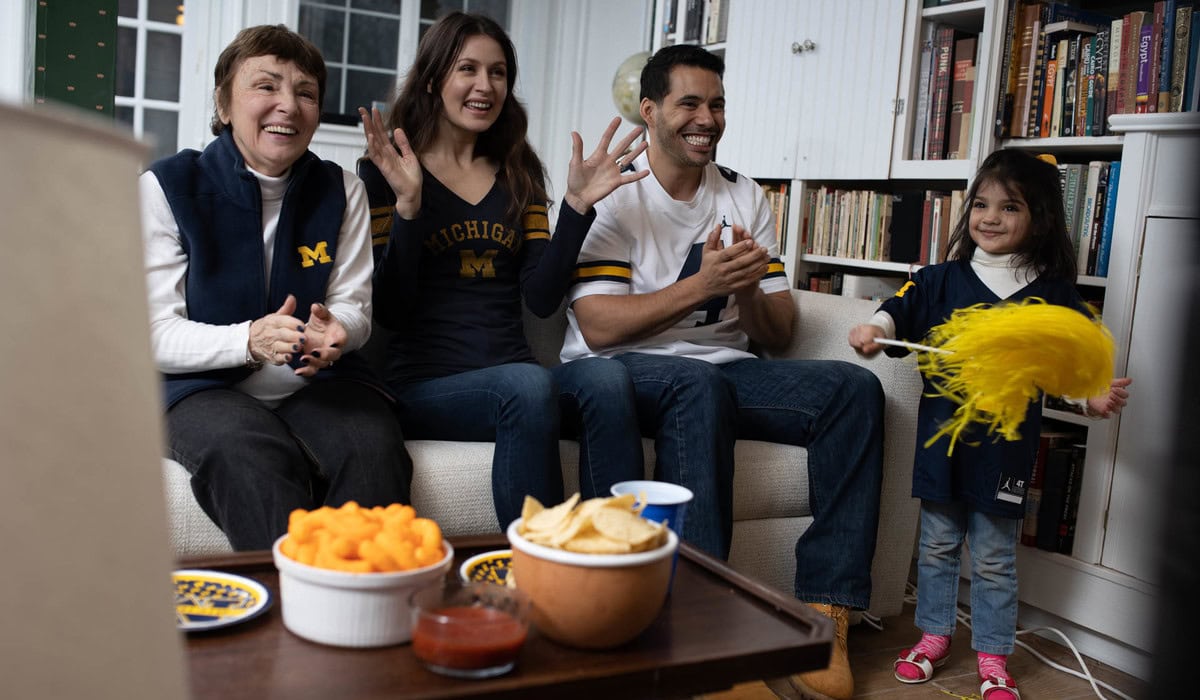 A family watches a Michigan game at home
