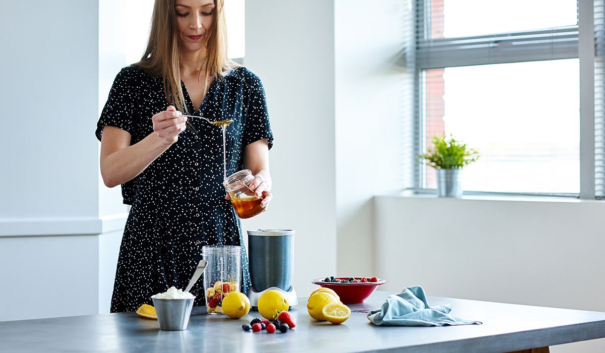 Woman Preparing Tropical Beverage At Home
