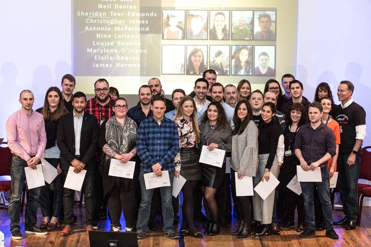 group photo on stage at a conference