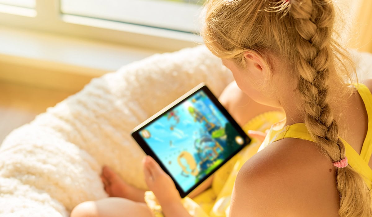 Girl Playing Game On Tablet Computer