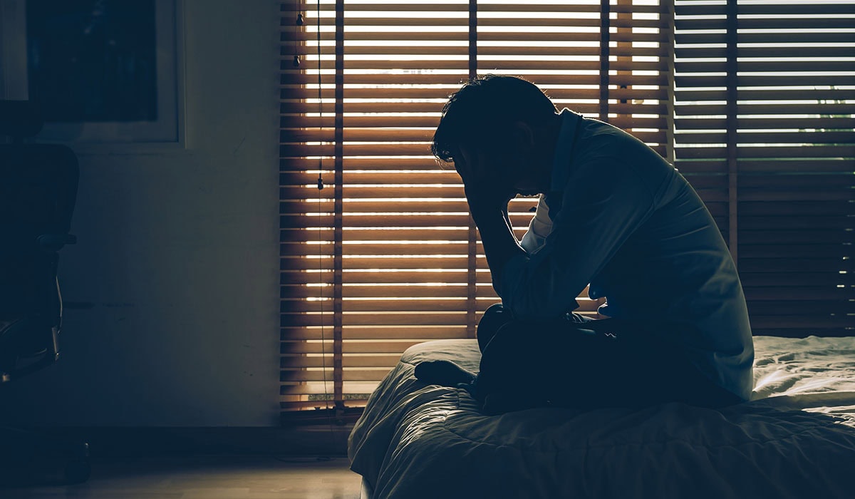 Sad Businessman Sitting Head In Hands On The Bed In The Dark Bedroom With Low Light Environment, Dramatic Concept, Vintage Tone Color