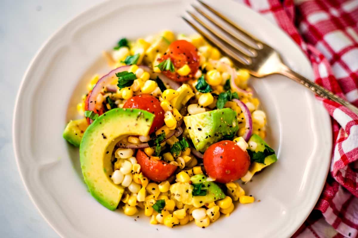 corn salad with sliced avocado