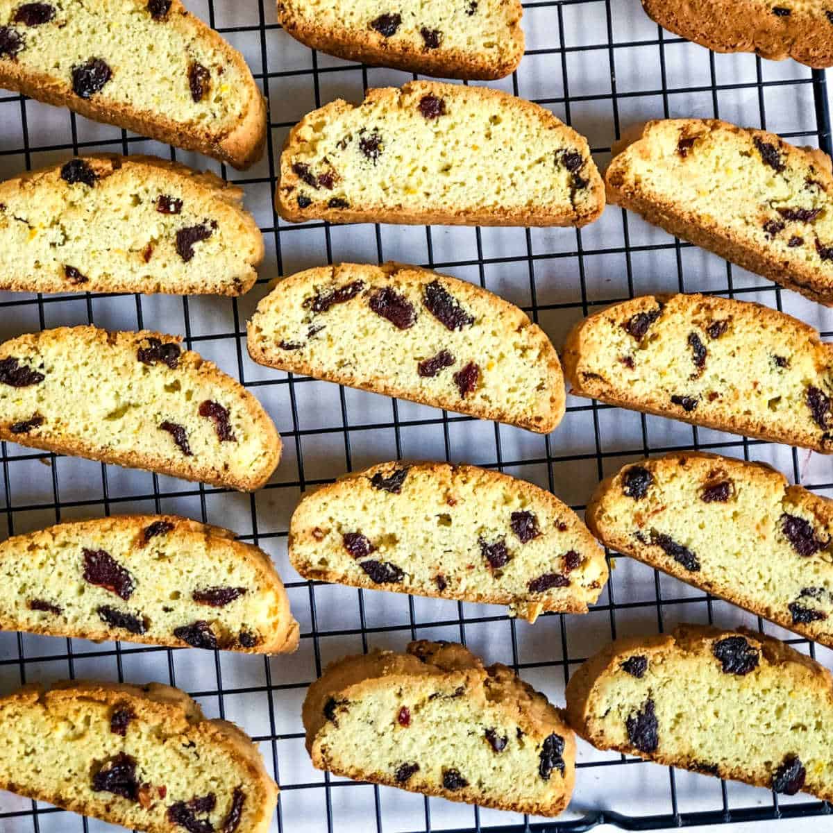 sliced cherry biscotti cooling on a wire rack