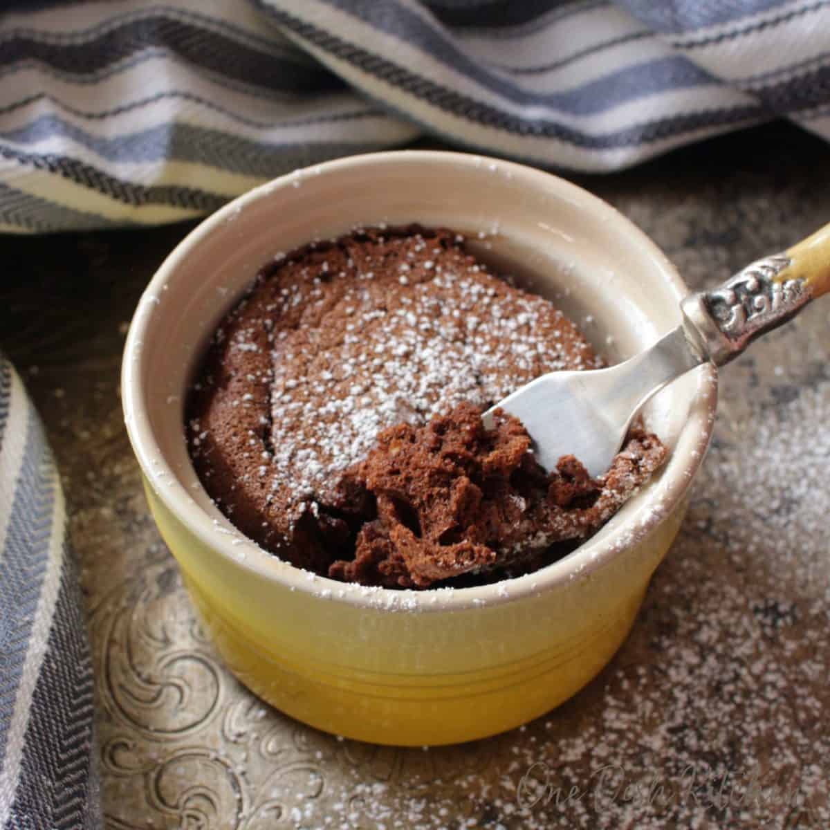 eating a chocolate cake with a fork.