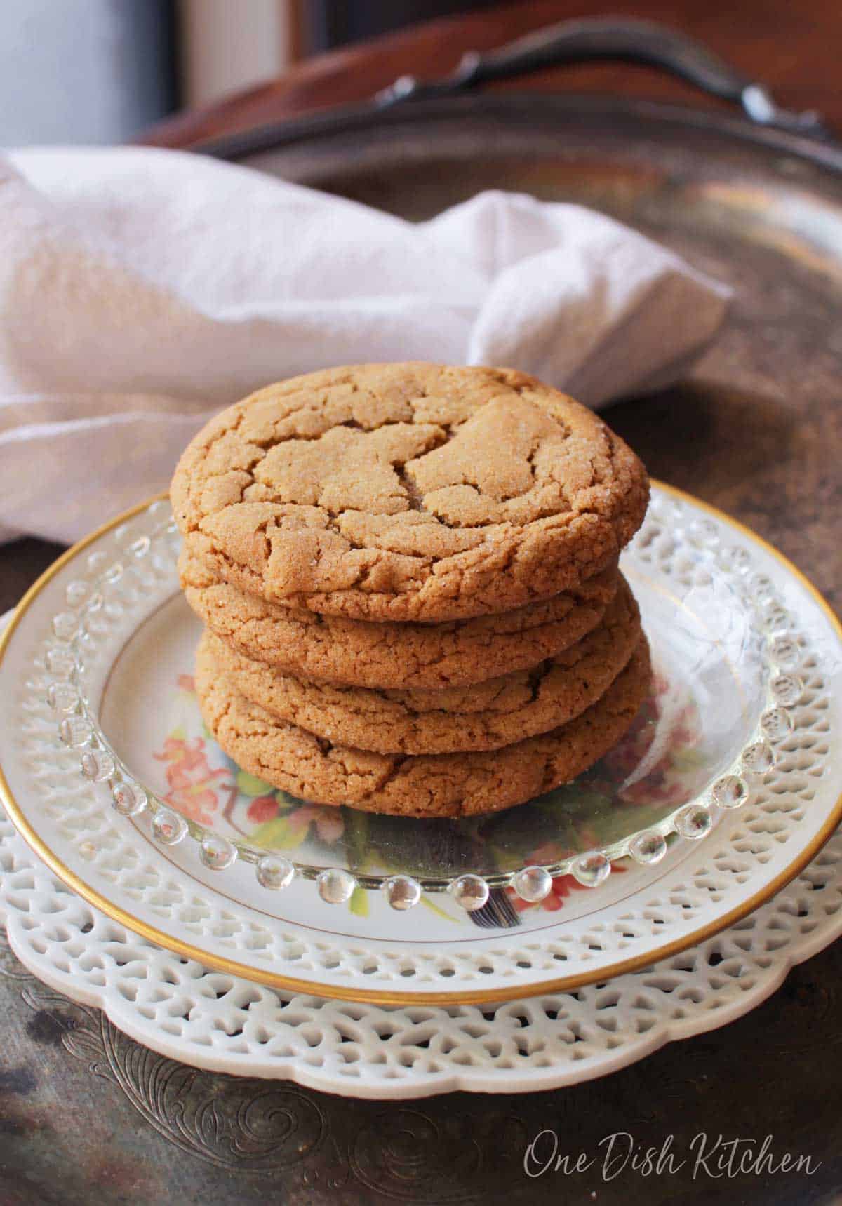 A stack of four soft ginger cookies plated on a metal tray