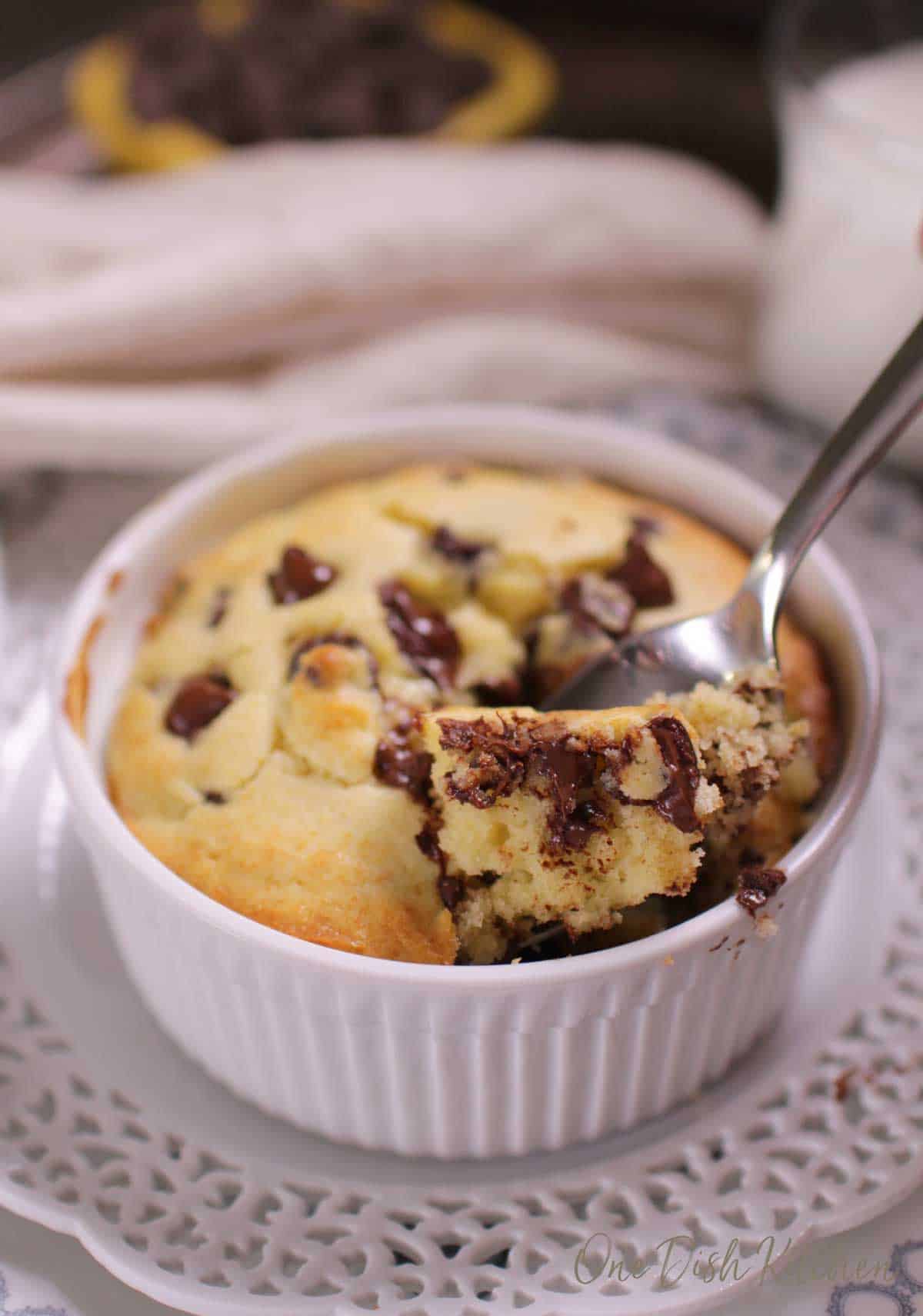 a spoon in a muffin topped with chocolate chips.