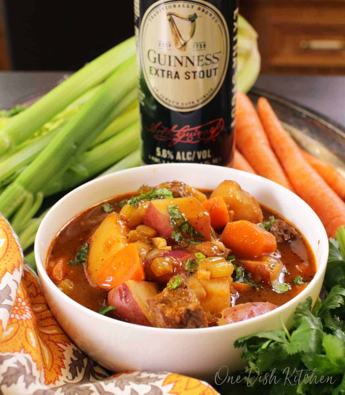a bowl of irish stew with a can of guinness stout in the background | one dish kitchen