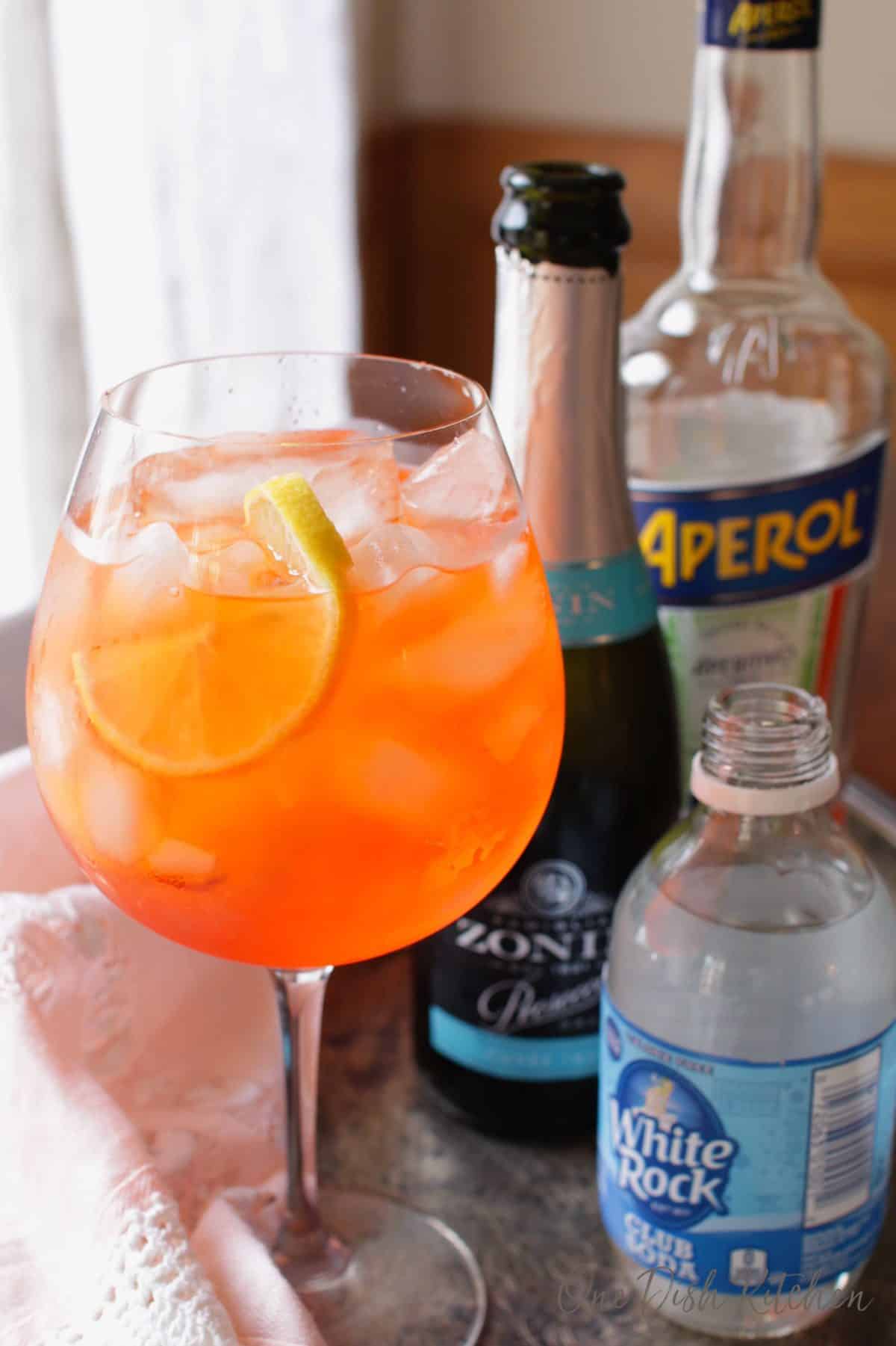 an aperol spritz and bottle of champagne, aperol and club soda | one dish kitchen