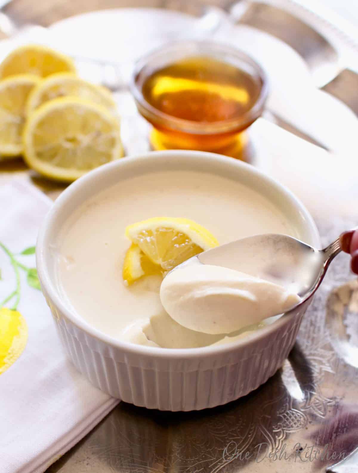 a spoon in a honey lemon custard on a tray | one dish kitchen