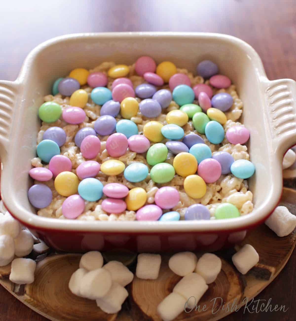 a rice krispies treat topped with pastel m&m's | one dish kitchen