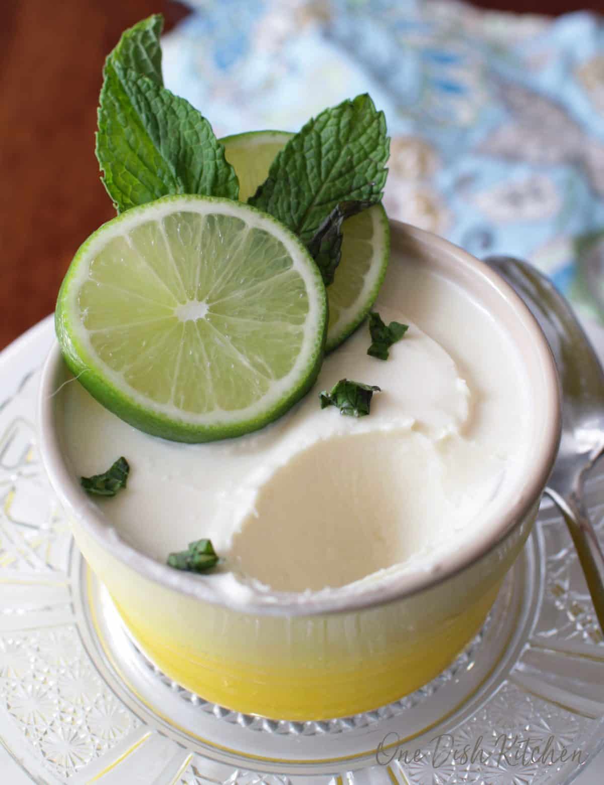 eating a posset topped with lime slices and mint.