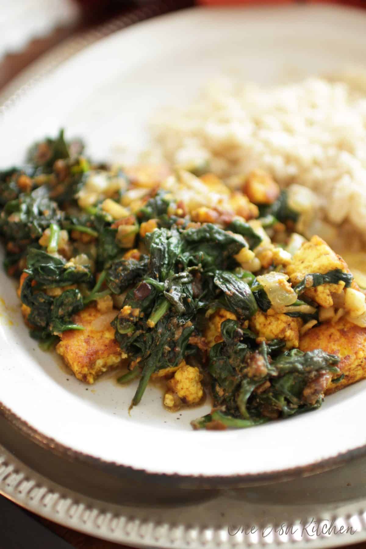 A close up of saag paneer on a plate with white rice