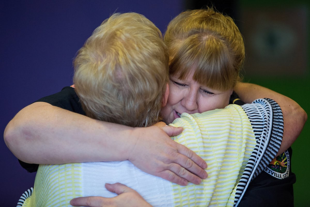 Gainesville Chief of Police Carol Martin, WC '88, hugs Judy Grove, after having a conversation during a Coffee With A Cop event. (AJ Reynolds/Brenau University)