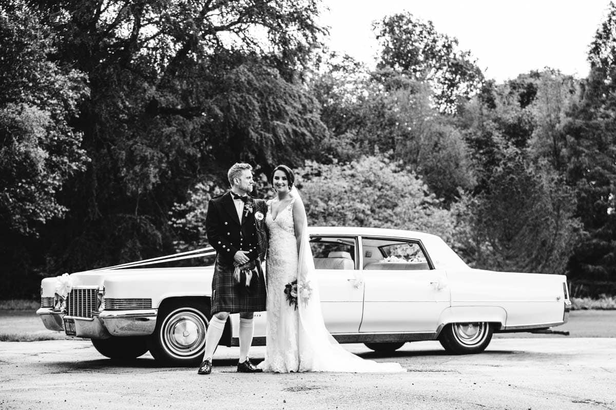 bride and groom with 1970's classic wedding car
