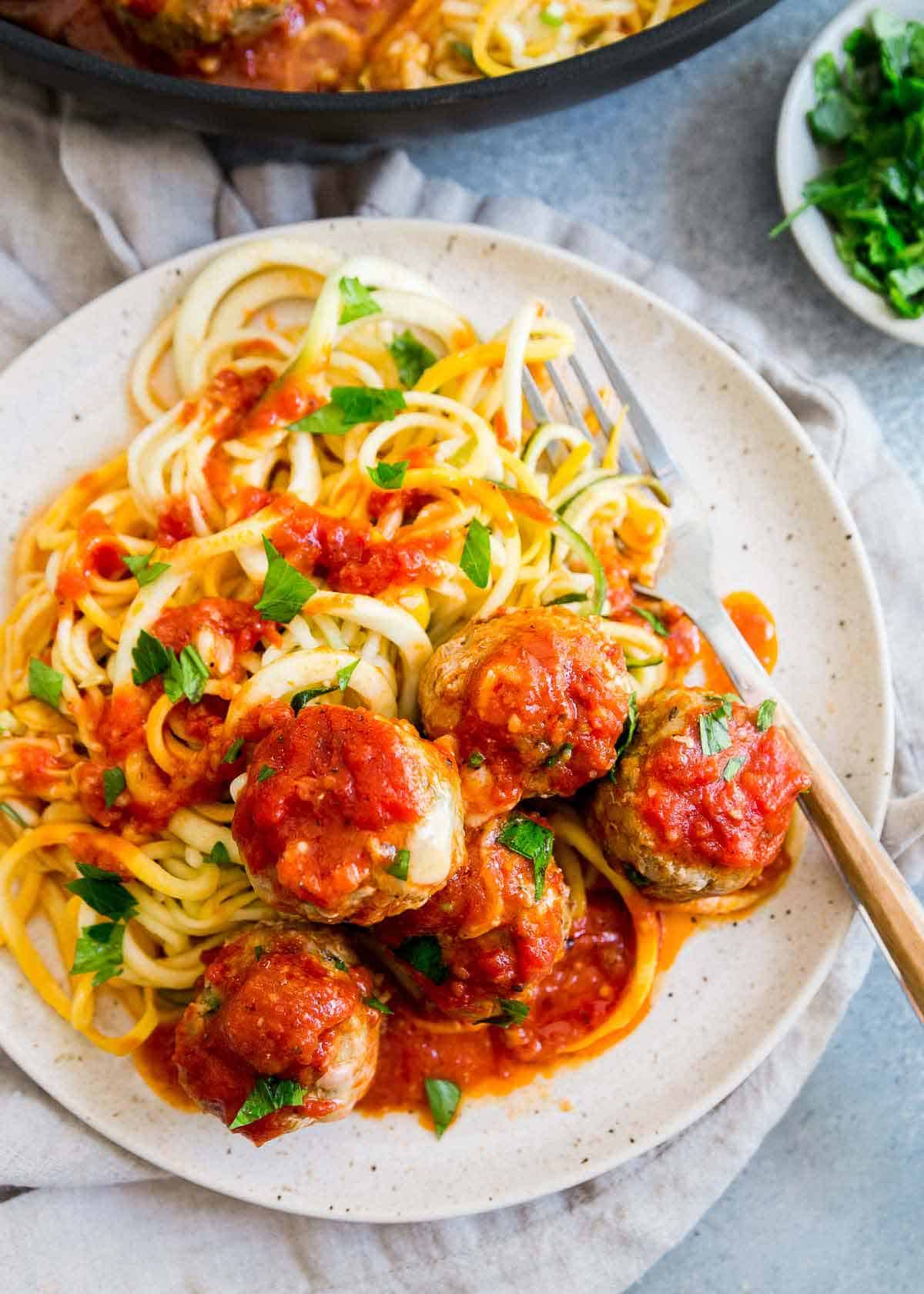 Turkey zucchini meatballs stuffed with cheddar cheese in marinara sauce made stovetop in a skillet.