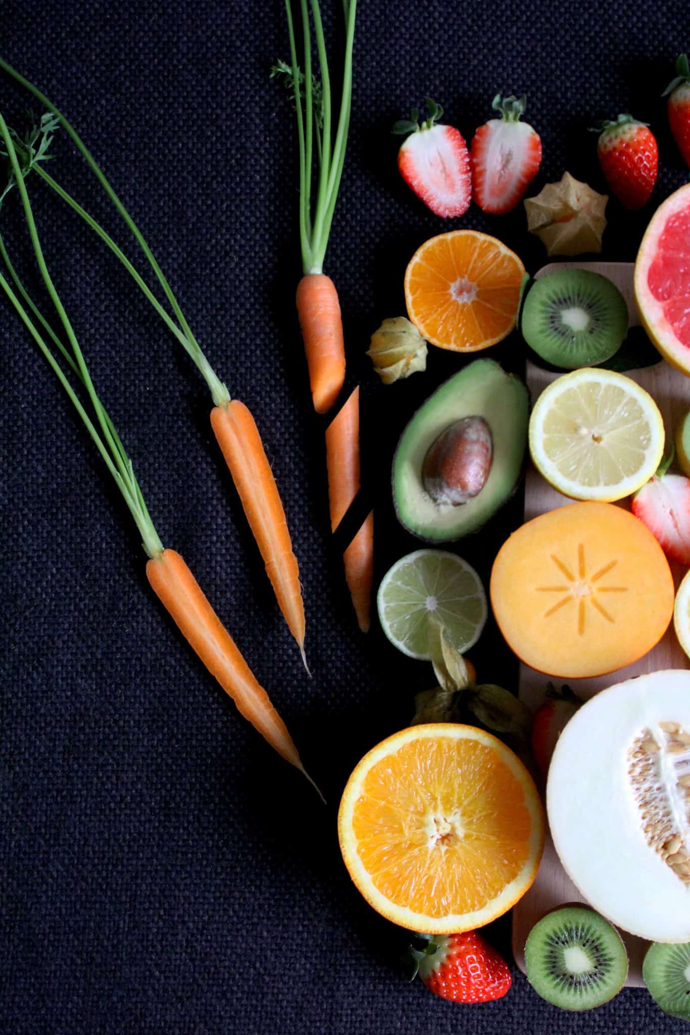 Fruit and vegetables, sliced, on a dark background