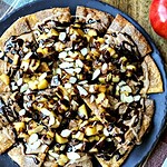 CHOCOLATE Apple Pie Nachos make a fun party dessert. Cinnamon pie dough “tortilla chips” are loaded with a brown sugar apple compote, decadent chocolate ganache, a cinnamon glaze, and slivered almonds. #apple #chocolate #pie #nachos #dessert #recipe #partyfood #ganache