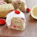 A slice of Pressure Cooker Strawberry Lemon Poppyseed Breakfast Cake on a wooden chopping board