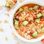 Top shot of creamy enchilada soup in a white bowl