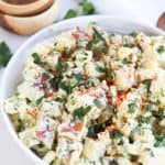 bowl of potato salad with chopped parsley