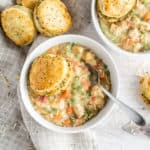 Bowl of chicken pot pie with a biscuit on top