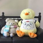 Chick and bear on leather loveseat