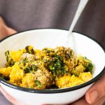 Hands holding Vegan Pasta Bake in a bowl