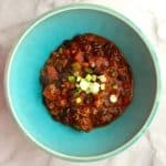 Top Black Bean Chili with some scallions.