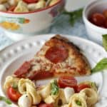 Turn pizza night into party night with this delicious Caprese Tortellini Salad. This recipe is the perfect quick side dish for a weeknight dinner or party.