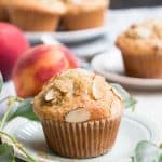 Peach Ricotta Olive Oil Muffins. Fluffy and full of fresh peaches, creamy ricotta and olive oil. A crunchy lid of almonds and raw sugar top them off!