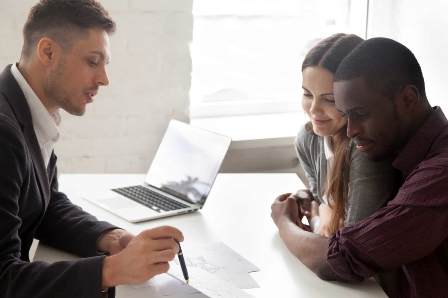 Couple with real estate broker Couple speaking with real estate broker