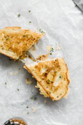 A Caramelized Onion, Whole Grain Mustard, and Gruyere Grilled Cheese perfect for spring. Just look at that gorgeous cheese pull!!!