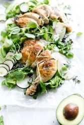 A loaded green chicken salad with watercress, green apples, farro, and a "creamy" dairy-free avocado dressing! So perfect for summer entertaining.