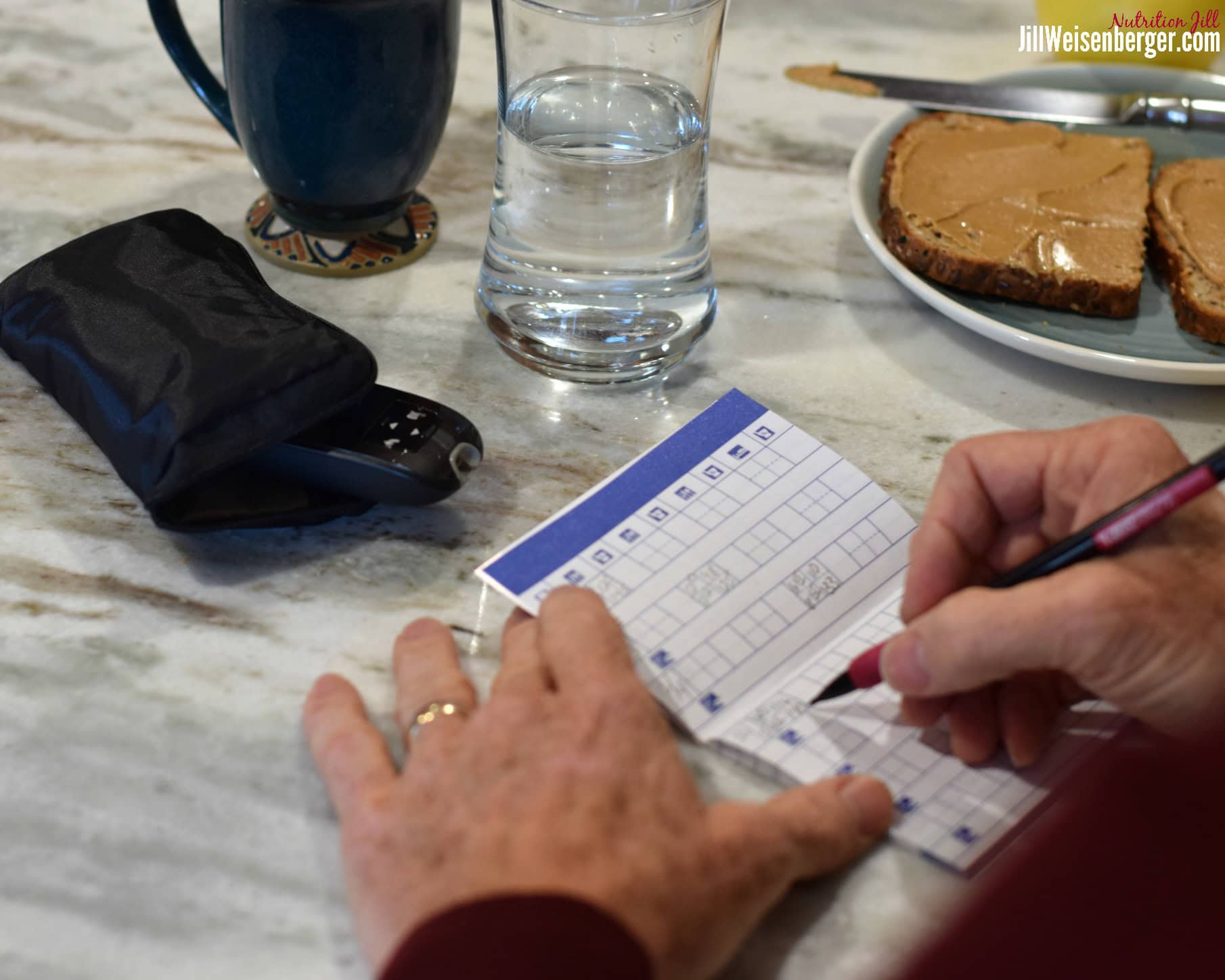 Man recording number after testing blood sugar
