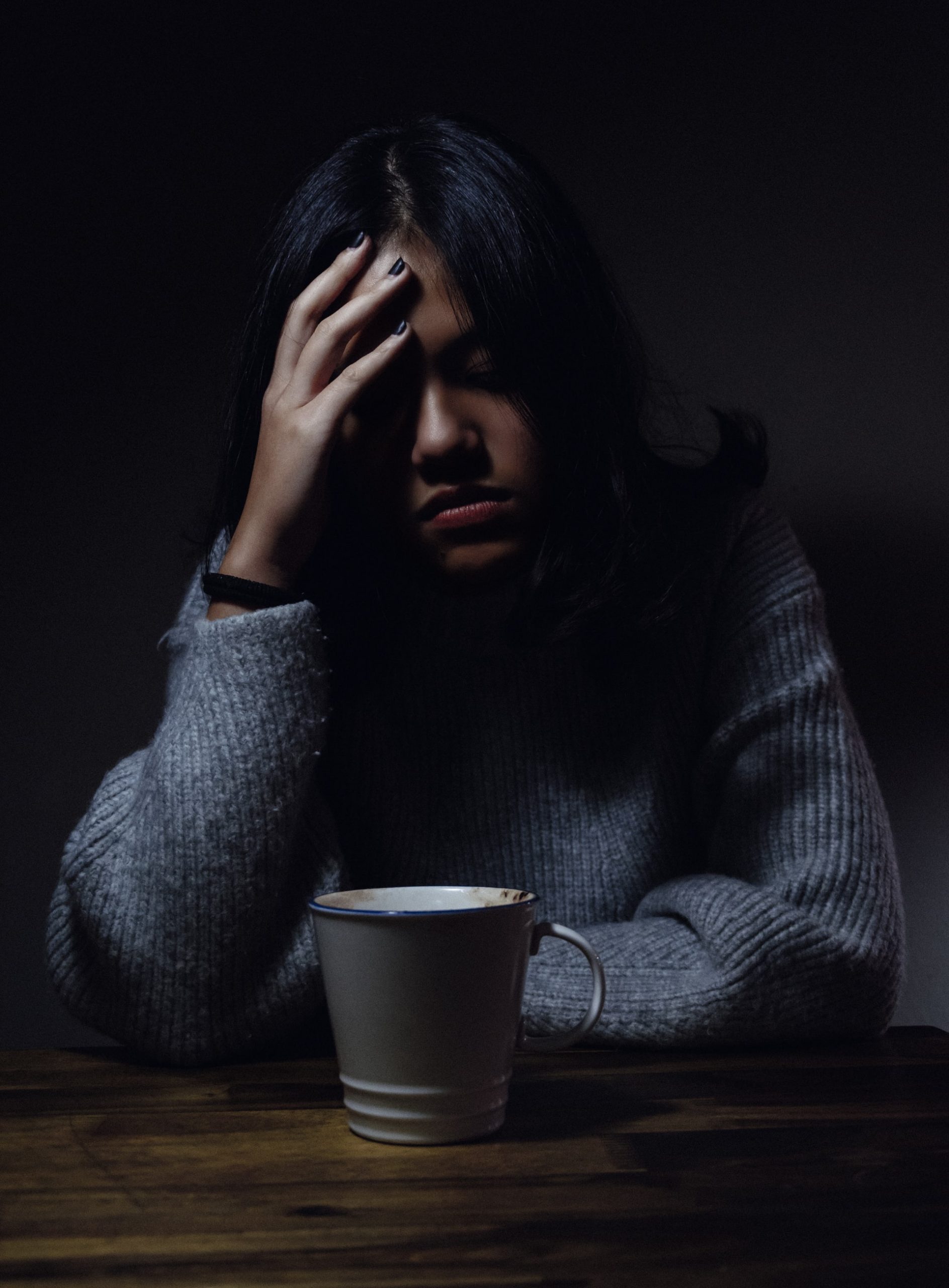 Depressed person with coffee cup