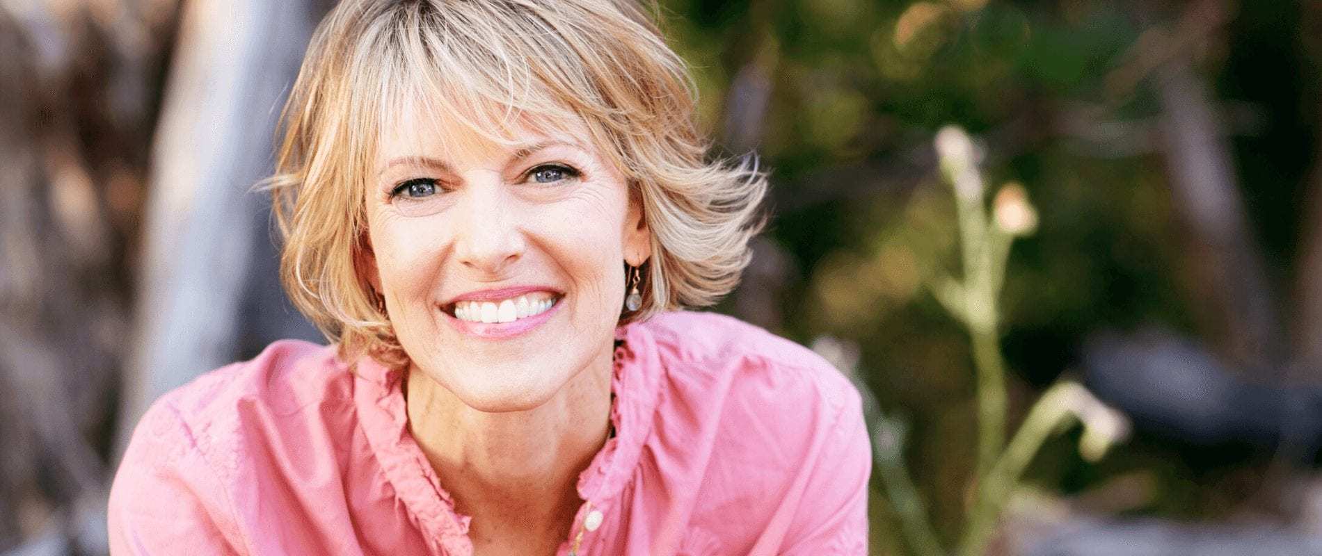 Elizabeth Hunter Diamond, clairvoyant & psychic energy healer, smiles in pink shirt.